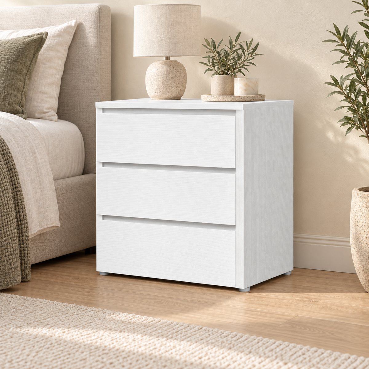 White three-drawer bedside table